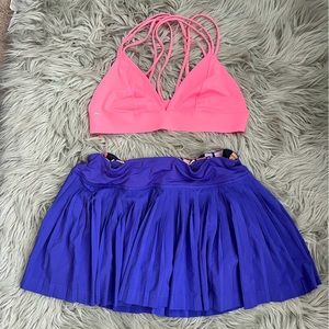 Lululemon purple tennis skirt with zipper pocket and pocket in front.